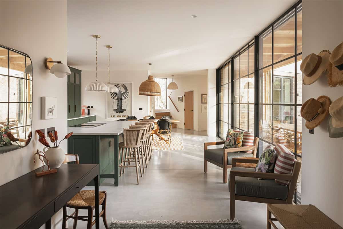 Hazelbridge Cottage open-plan kitchen with green island, steel-framed windows, and garden views